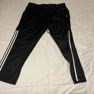 Adidas track pants with snap buttons half way up the legs